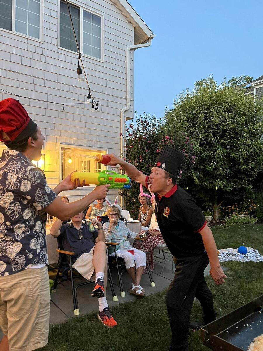 Hibachi chef entertaining guests at a backyard hibachi party in CT