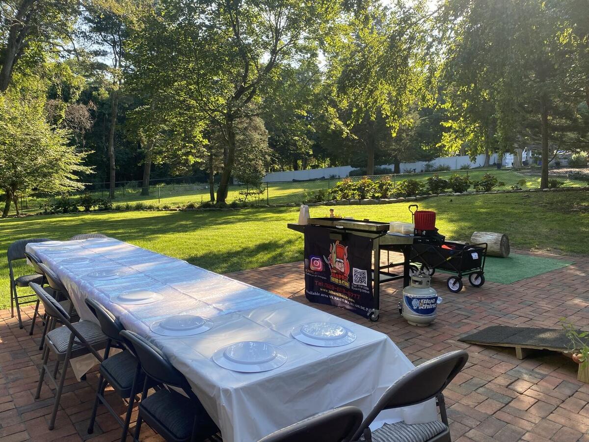 Long table setup for a large hibachi buffet party in Connecticut