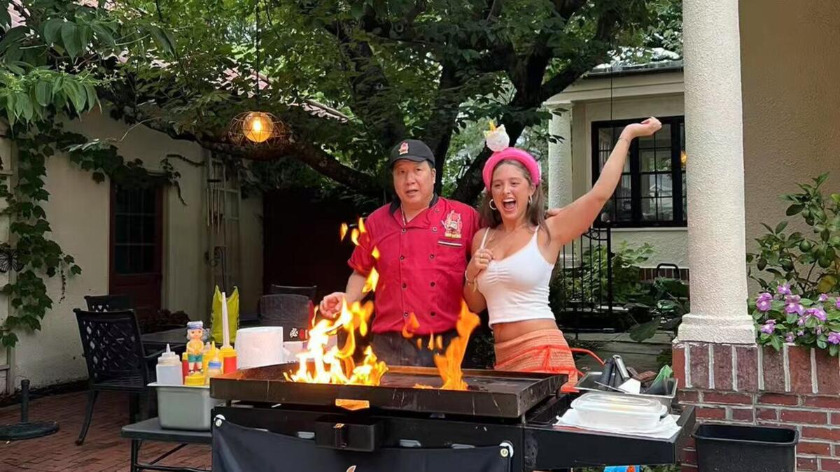 Private hibachi chef cooking with flames at a Connecticut backyard party